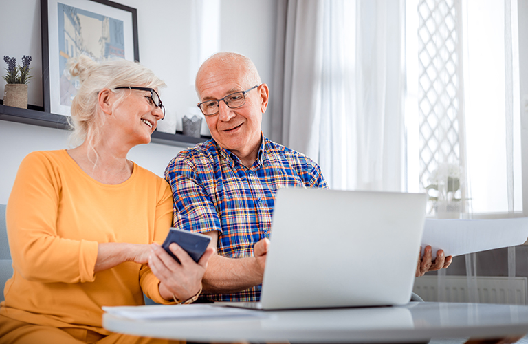 Senior couple with laptop computer